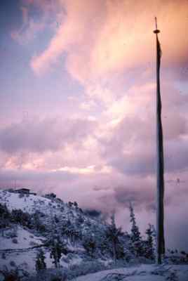 A Prayer Flag and Snow Greets the Sunrise in Bhutan